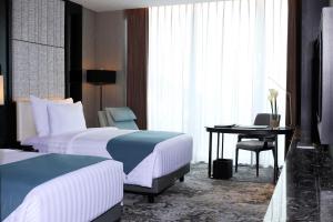 Letto o letti in una camera di JHL Solitaire Gading Serpong