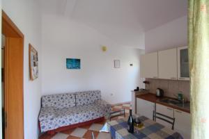 a living room with a couch and a table at Apartments Ines in Orebić