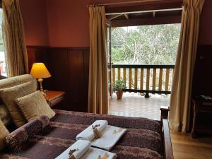 a bedroom with a bed with a view of a porch at Bridgefield Guest House in Margaret River Town