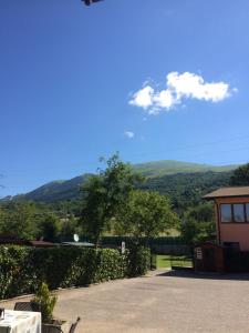 a view of the mountains from a house with a table at Hotel Edelweiss in San Zeno di Montagna