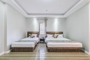 Postel nebo postele na pokoji v ubytování Shengli Hydrotherapy Vacation Hotel