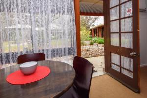 a table and chairs with a bowl on top of it at River Country Inn in Moama