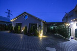 a house with a lit up driveway at night at Armada Villa Hotel in Baku