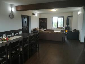 a living room with a couch and a table at Casa Maria in Piatra Fantanele