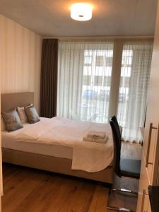 a bedroom with a large bed and a window at Residence Appartements in Zurich