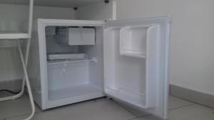 a white refrigerator with its door open in a kitchen at Il Corvino in Diamante