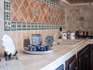 a kitchen with blue and white dishes on a counter at Villetta Rombi in Calasetta +48 photos