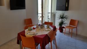 a dining room table with a red table cloth and chairs at Cabà Holiday Bardolino Gritti in Bardolino
