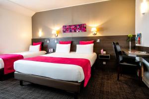 מיטה או מיטות בחדר ב-Hotel Des Dunes
