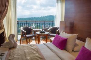 a hotel room with a bed and a large window at Swiss Residence Kandy in Kandy +39 photos