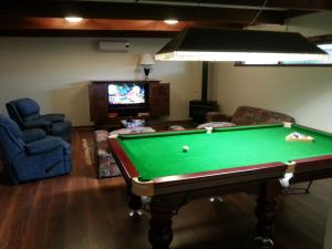 a living room with a pool table and a tv at The Palms in Gawler
