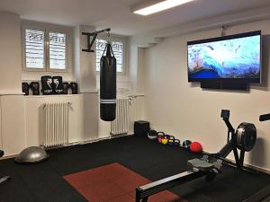 a room with a gym with a punching bag on the wall at Hotel Eden in Geneva