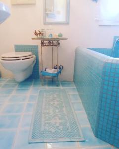a bathroom with a tub and a toilet and a sink at Villa La Cuata in Costa Paradiso