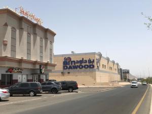 a building with a sign on the side of a street at Al Majdah Hotel in Medina