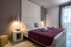 Postel nebo postele na pokoji v ubytování Galaxy Hotel
