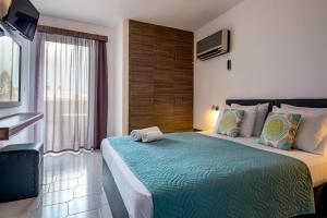 Postel nebo postele na pokoji v ubytování Galaxy Hotel