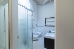 a bathroom with a glass shower and a toilet at La Betulla in Mantova +8 photos