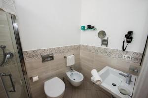 a small bathroom with a toilet and a sink at La Suite Tropea in Tropea +41 photos