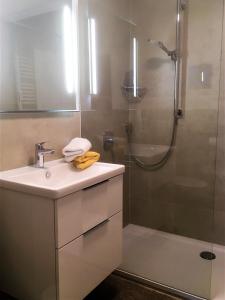 a bathroom with a sink and a shower at Alpenflair Ferienwohnungen Whg 305 in Oberstdorf