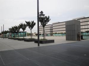 a man standing in front of a building with trees at Best Western Plus Net Tower Hotel Padova in Padova