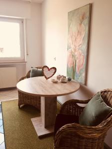 a table with a heart on it in a room at Kant-Haus in Viernheim