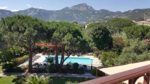 uma vista para a piscina a partir da varanda de um resort em Résidence A Merula em Calvi