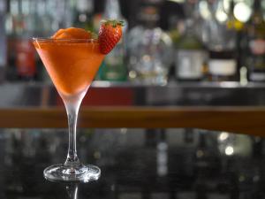 a cocktail with a strawberry in a martini glass at K+K Hotel Fenix in Prague