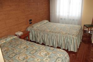 Postel nebo postele na pokoji v ubytování Hostal Castilla