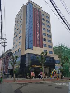 a large building with a large sign on it at Rosabell Hotel in Ansan