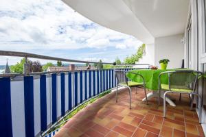 a balcony with a table and chairs and a view at Apart Hotel Stadtgarten in Überlingen