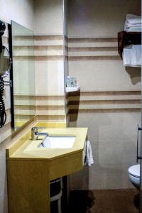 a bathroom with a sink and a mirror at Hotel Los Angeles in Santillana del Mar