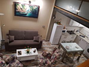 a living room with a couch and tables at Apartamentos Santa Justa in Ubiarco