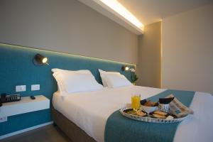 Postel nebo postele na pokoji v ubytování Airone City Hotel
