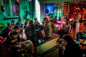 a group of people sitting in a bar at Jorplace Boutique Hostel in Scheveningen