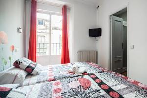 a bedroom with a bed with a quilt on it at Hostal Inter Plaza Mayor in Madrid