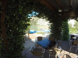 a patio with a table and chairs and a pool at Camping Port Massaluca in Pobla de Masaluca