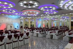 a large banquet hall with white tables and chairs at Hotel Zamok Korolya in Voronezh