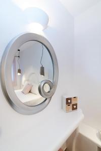 a mirror in a white room with a bed at Fouli's House at "Porto Vlastos" in Agios Ioannis Tinos +25 photos