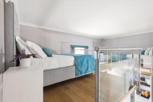 A bed or beds in a room at La Piazzetta Guest House