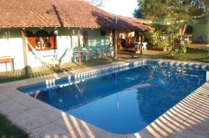 a swimming pool in front of a house at Hostel Iguazu Falls in Puerto Iguazú