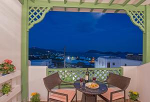 a gazebo with a table and chairs on a balcony at Agnadi studios in Maltezana