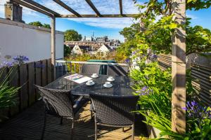 patio con mesa y sillas en el balcón en Dutch Masters Short Stay Apartments en Ámsterdam