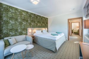 Säng eller sängar i ett rum på Am Weststrand Aparthotel Kühlungsborn