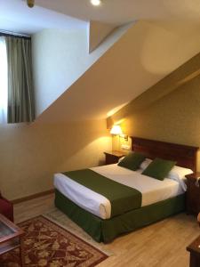 Postel nebo postele na pokoji v ubytování Hotel Cordón