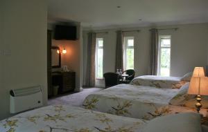 En eller flere senger på et rom på Applecroft House