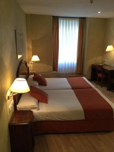 Postel nebo postele na pokoji v ubytování Hotel Cordón