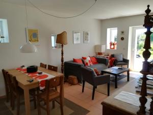 a living room with a couch and a table at Casa do Olival in Figueiró dos Vinhos