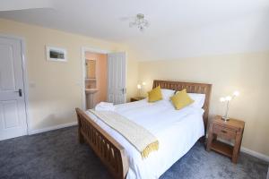 a bedroom with a large white bed with yellow pillows at Hillyard Mews in Newcastle