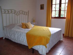 a bedroom with a bed with a yellow blanket on it at Les Petits Prés in Vitrac +108 photos