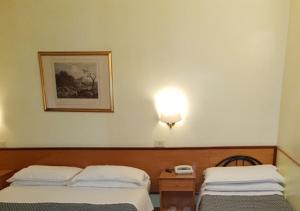 Posteľ alebo postele v izbe v ubytovaní Hotel Piemonte